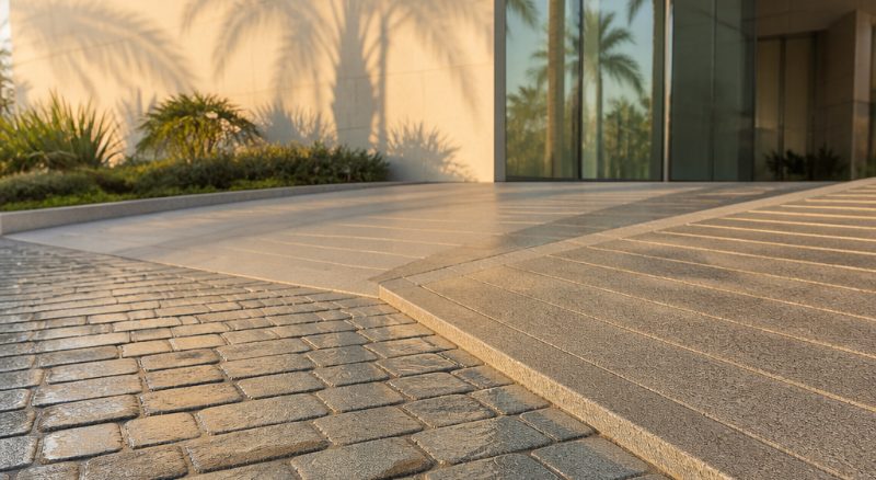 Outdoor cobble and tile paving on an access path, an example of a surface we pressure wash (demonstration image)